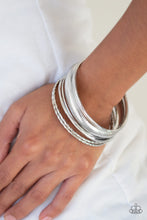 Load image into Gallery viewer, Paparazzi - The Customer is Always Bright - Set of 7 Silver Bangles
